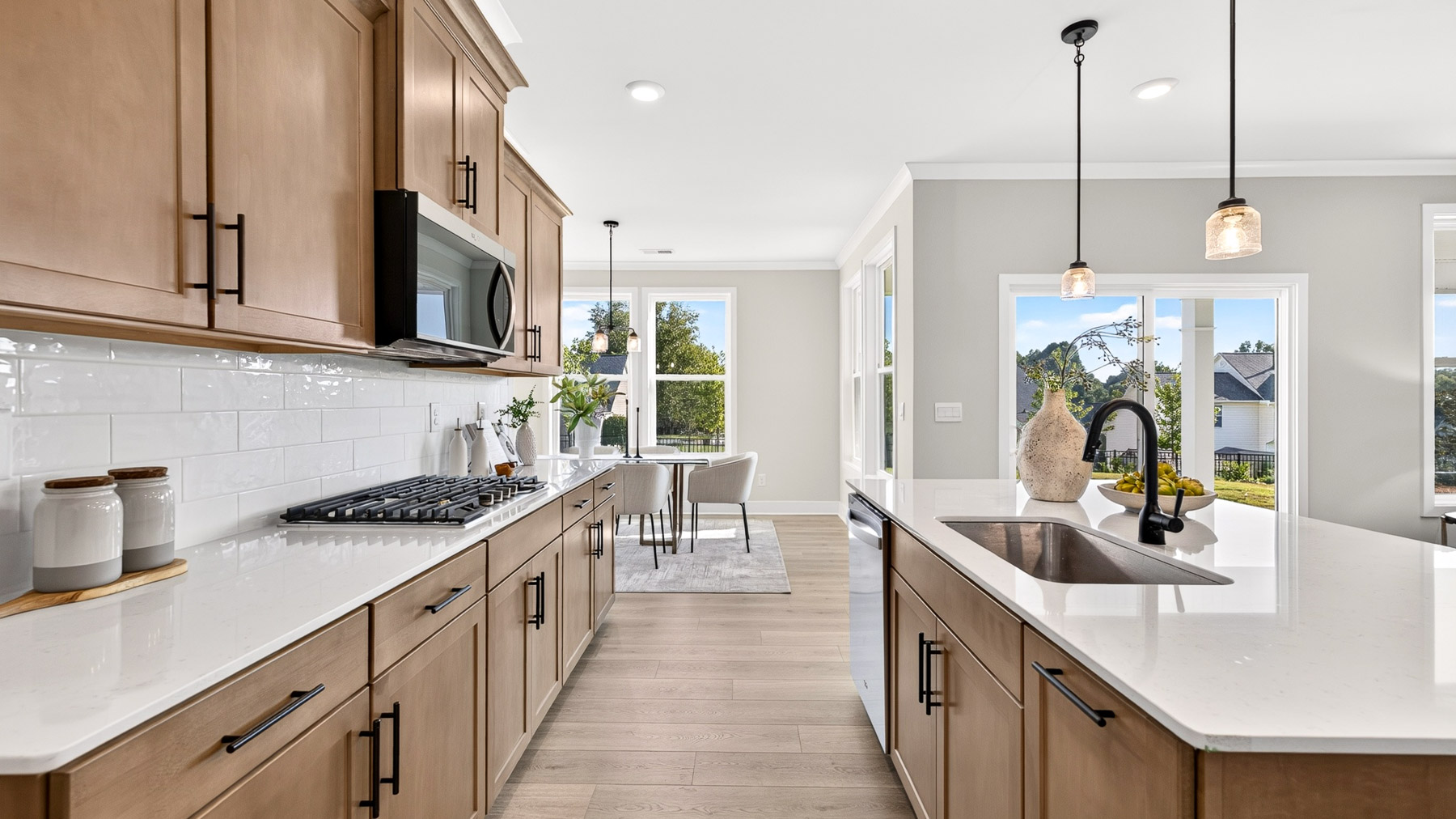 Kitchen and island with brown cabinets