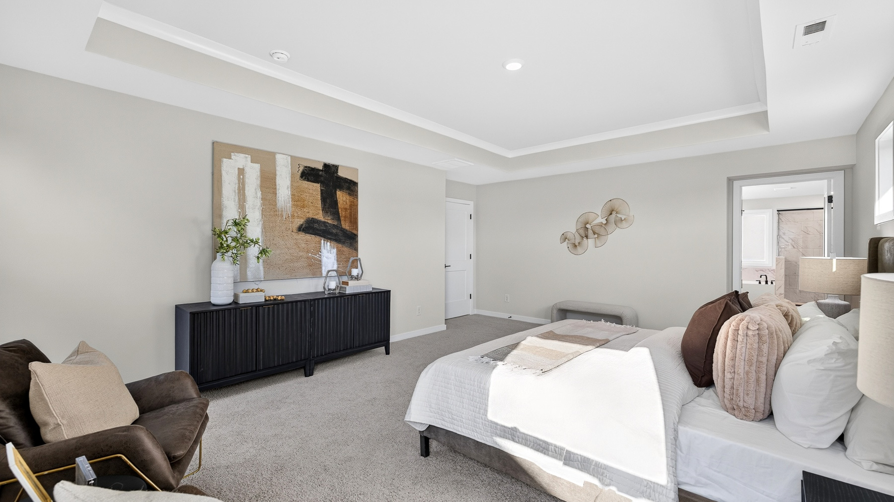 Primary carpeted bedroom with windows