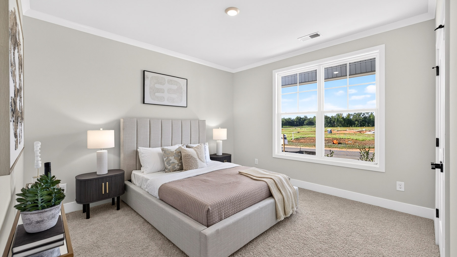 Carpeted bedroom with windows
