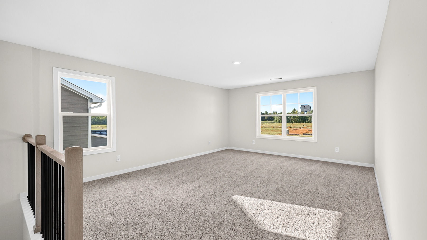 Carpeted bedroom with windows
