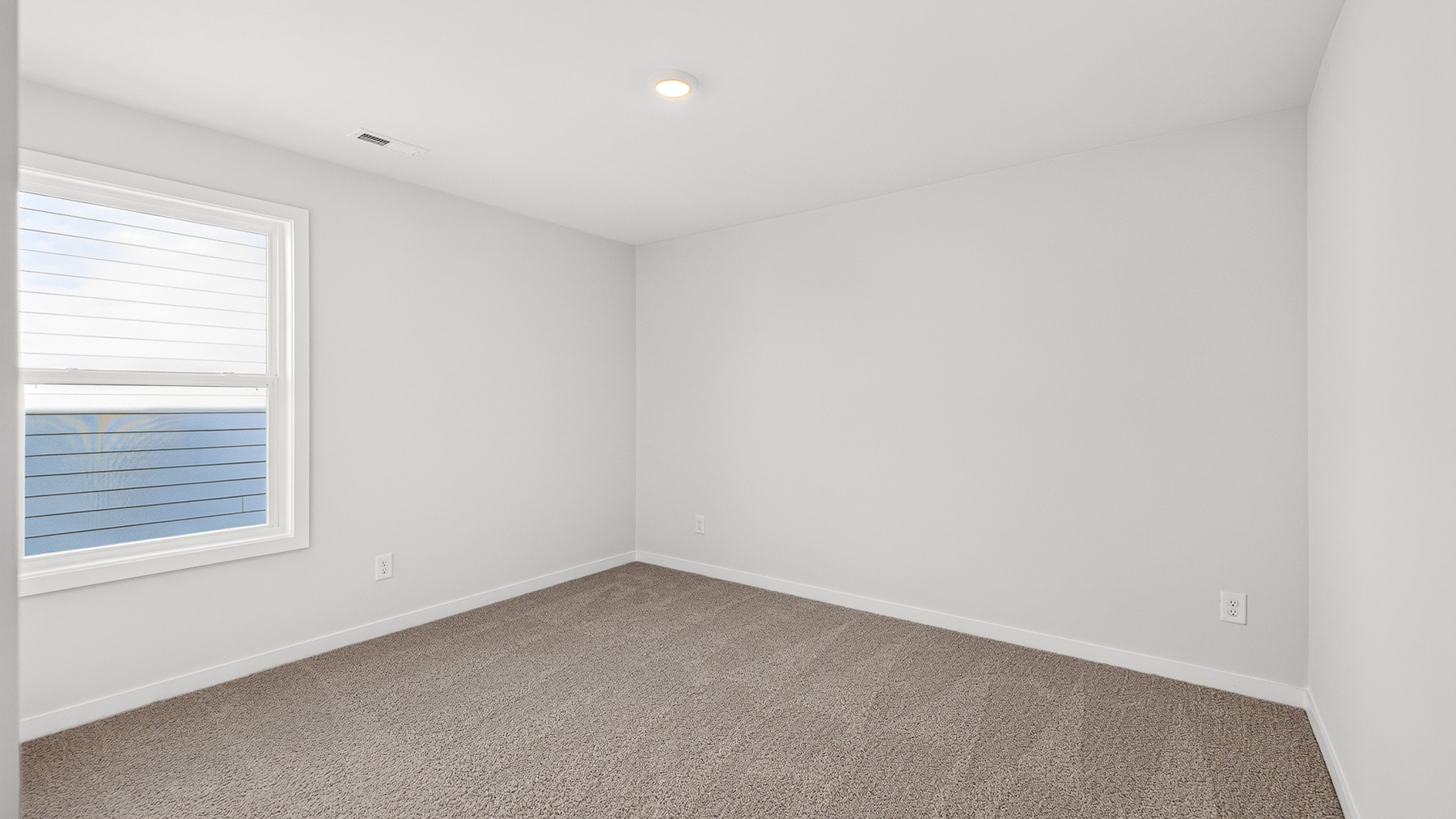 Carpeted bedroom with windows