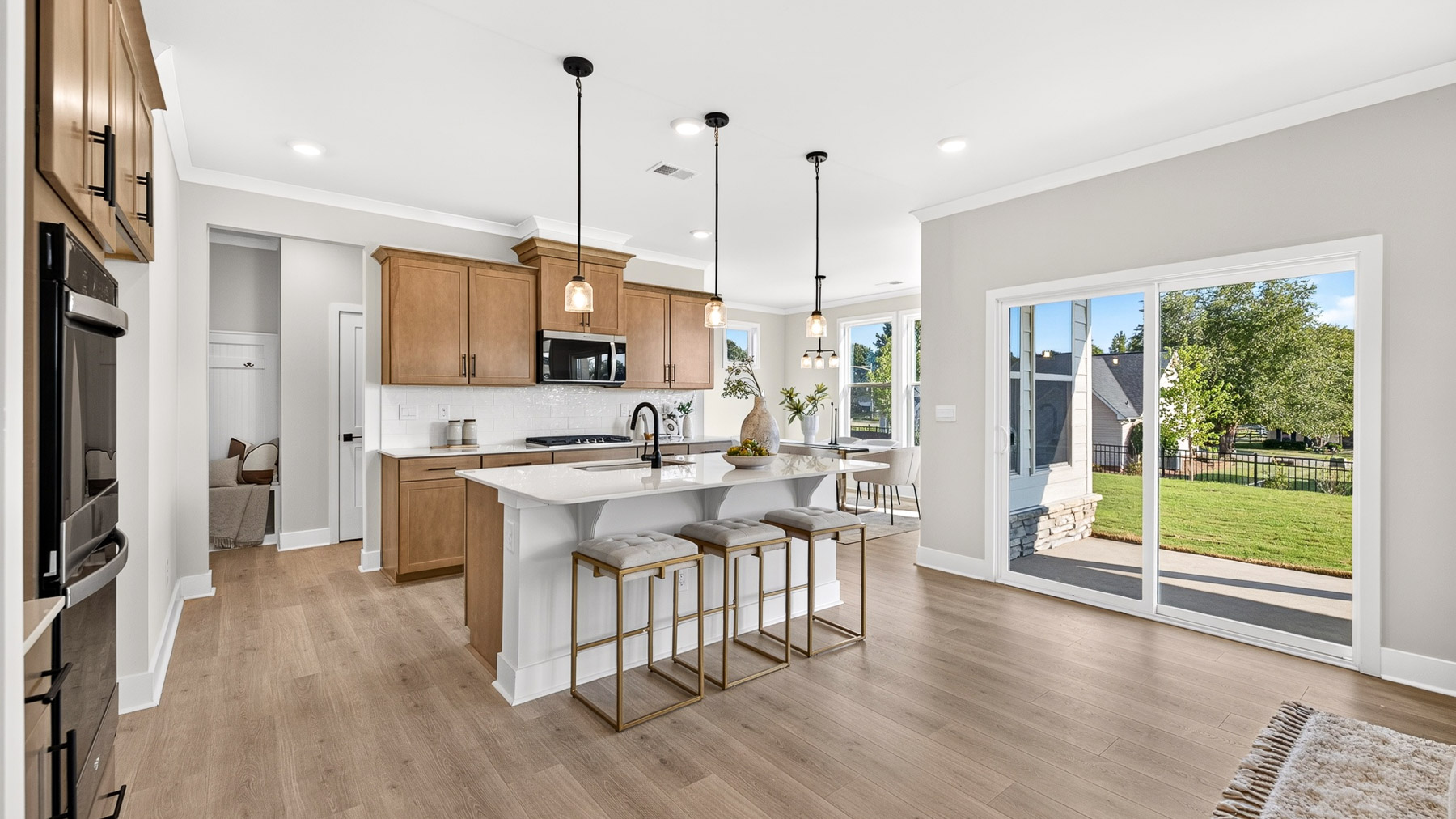 Kitchen and island with brown cabinets
