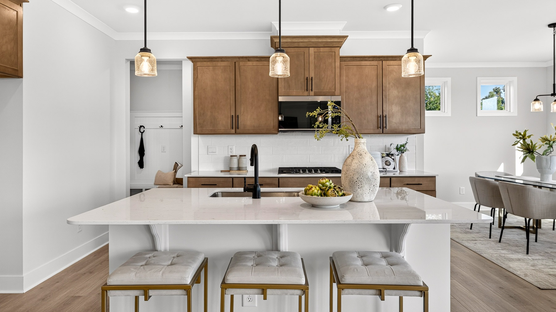 Kitchen and island with brown cabinets