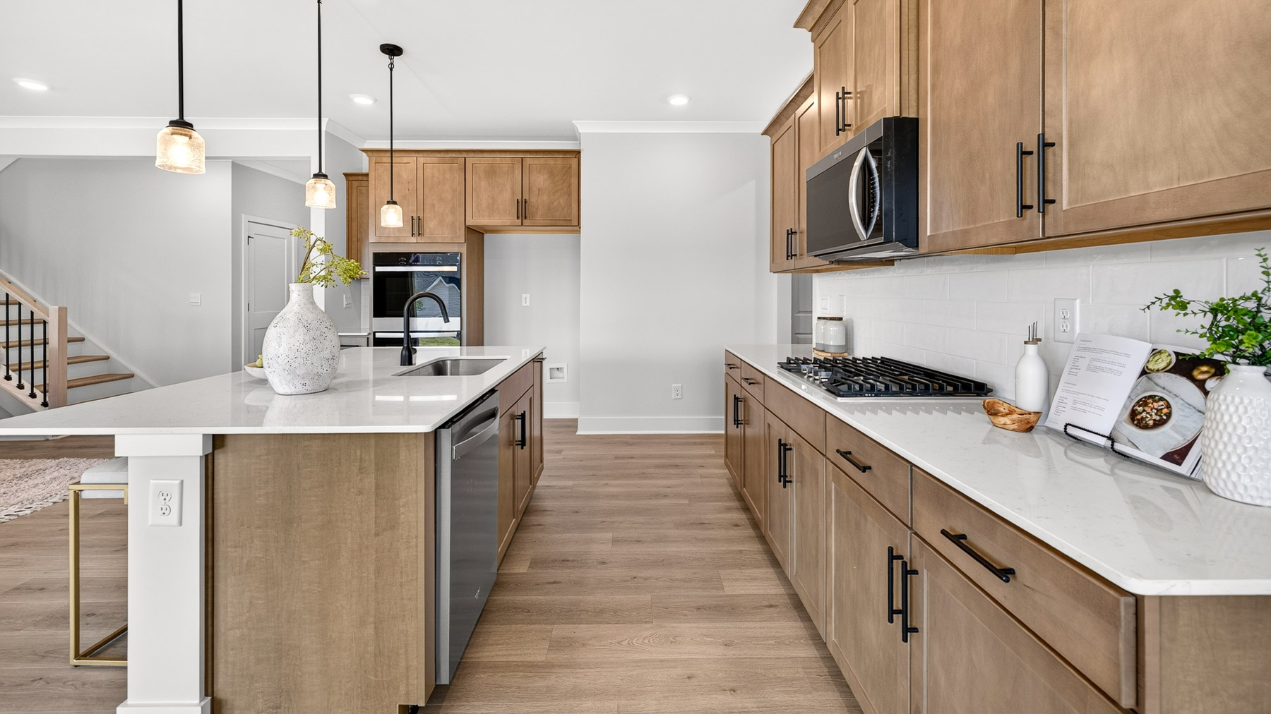 Kitchen and island with brown cabinets