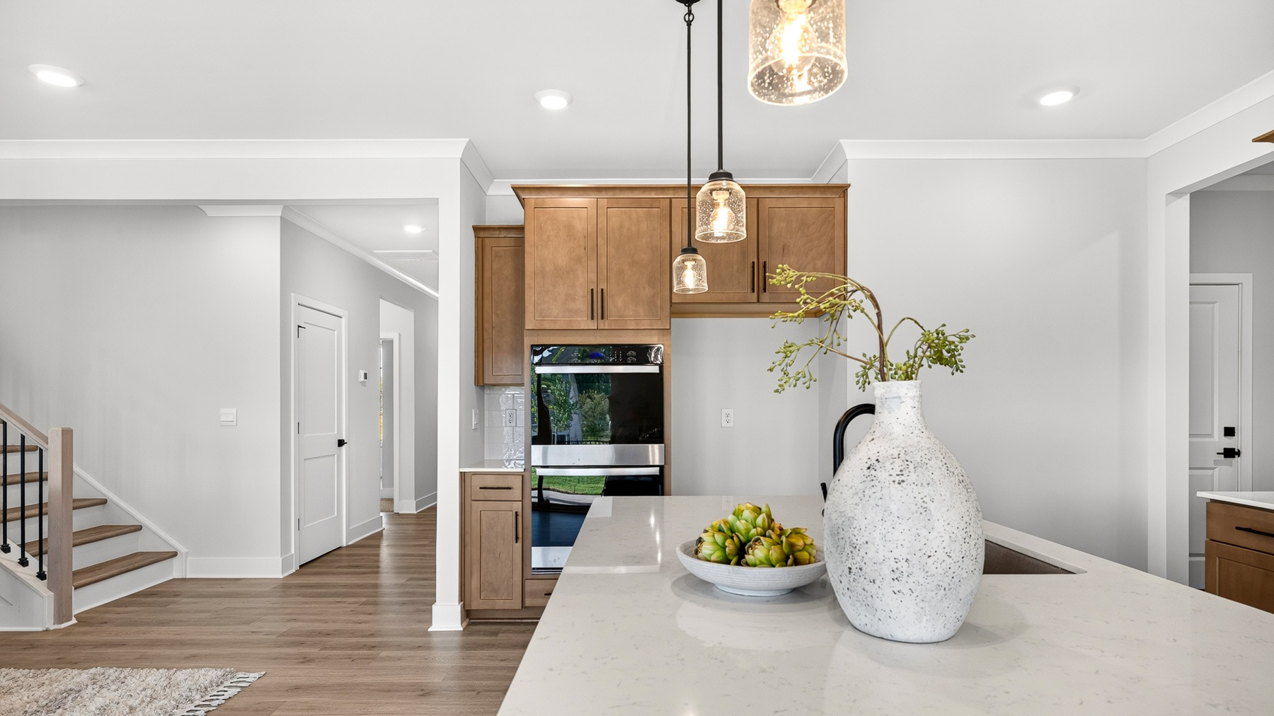 Kitchen and island with brown cabinets