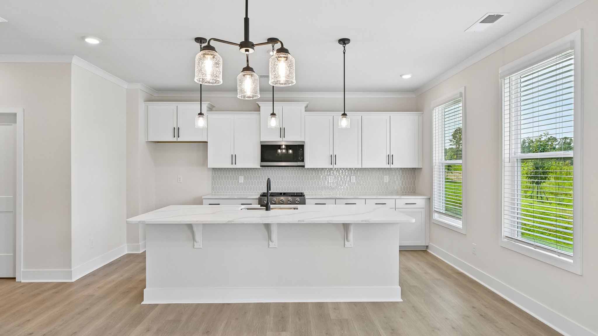 Kitchen and island with stainless steel appliances
