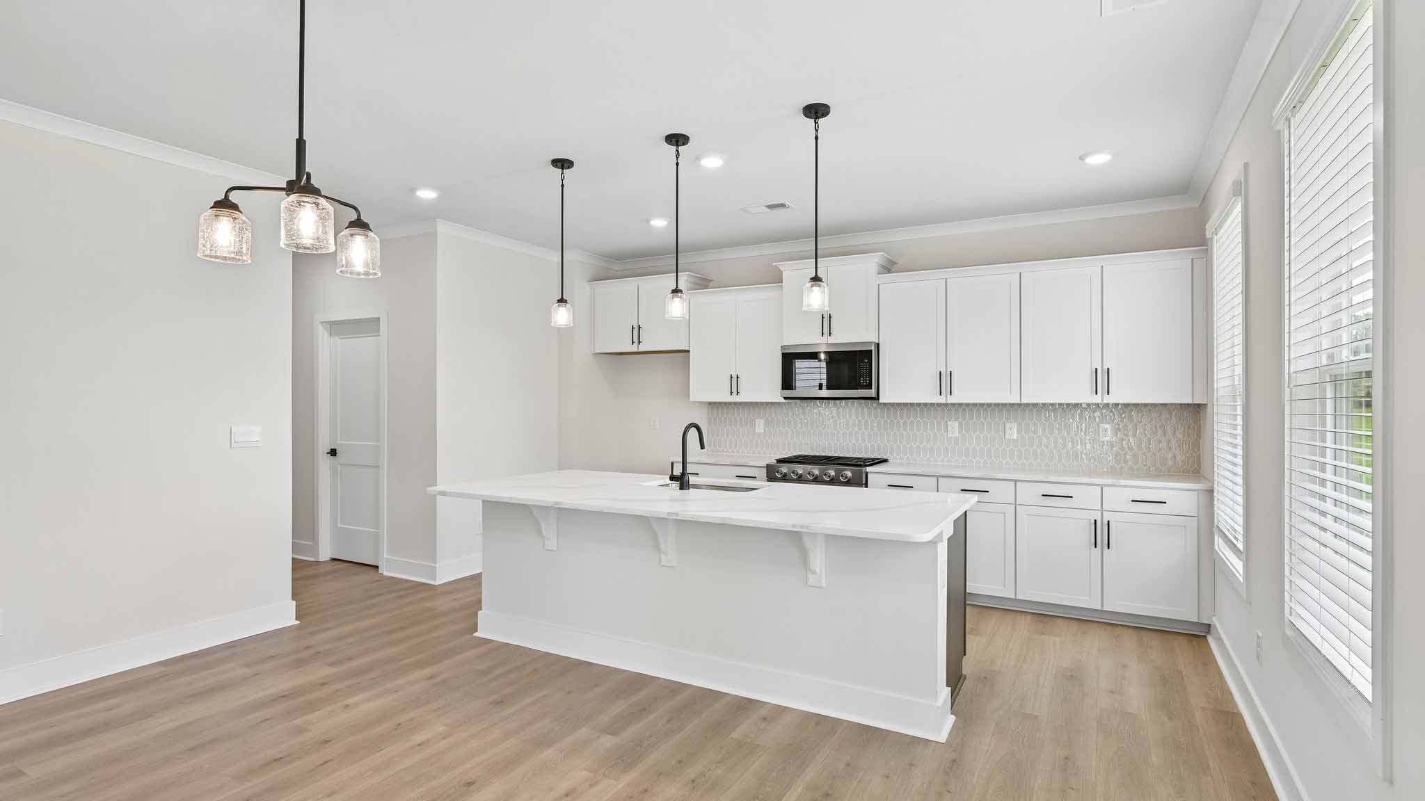 Kitchen and island with stainless steel appliances