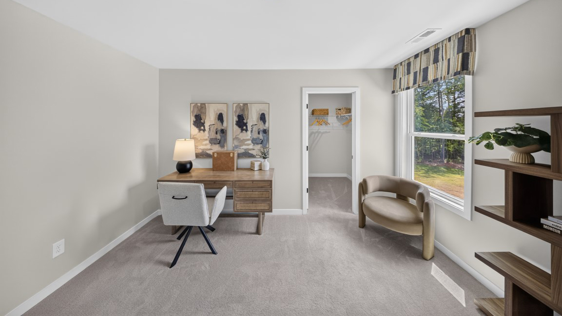 Carpeted bedroom/office staged