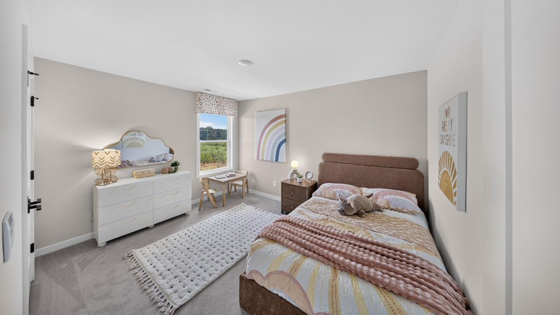 Carpeted bedroom with windows