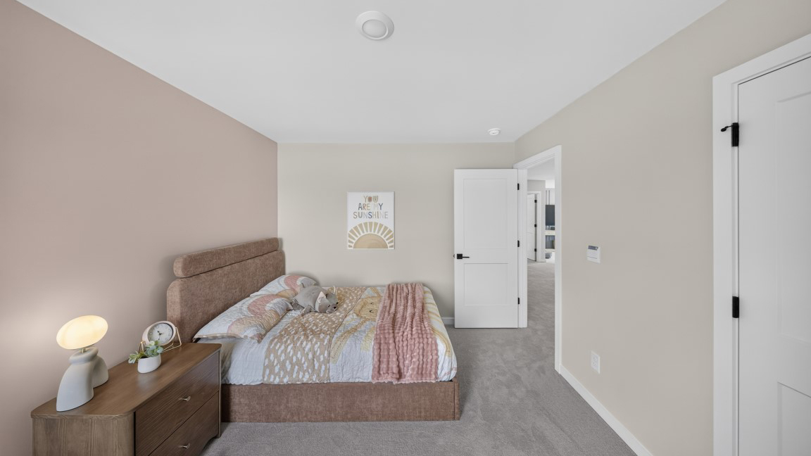 Carpeted bedroom with windows