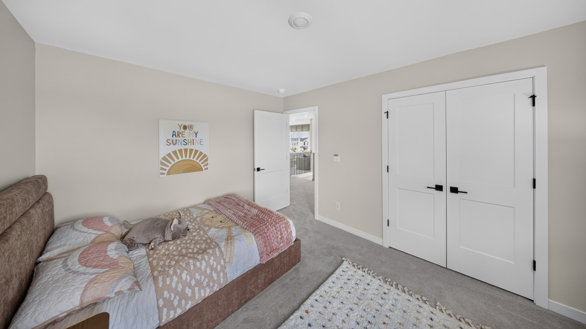 Carpeted bedroom with windows