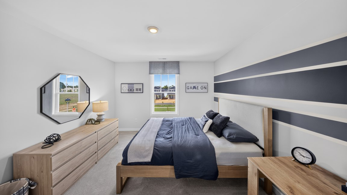 Carpeted bedroom with windows