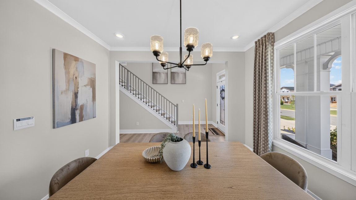 Dining area by the stairs with windows
