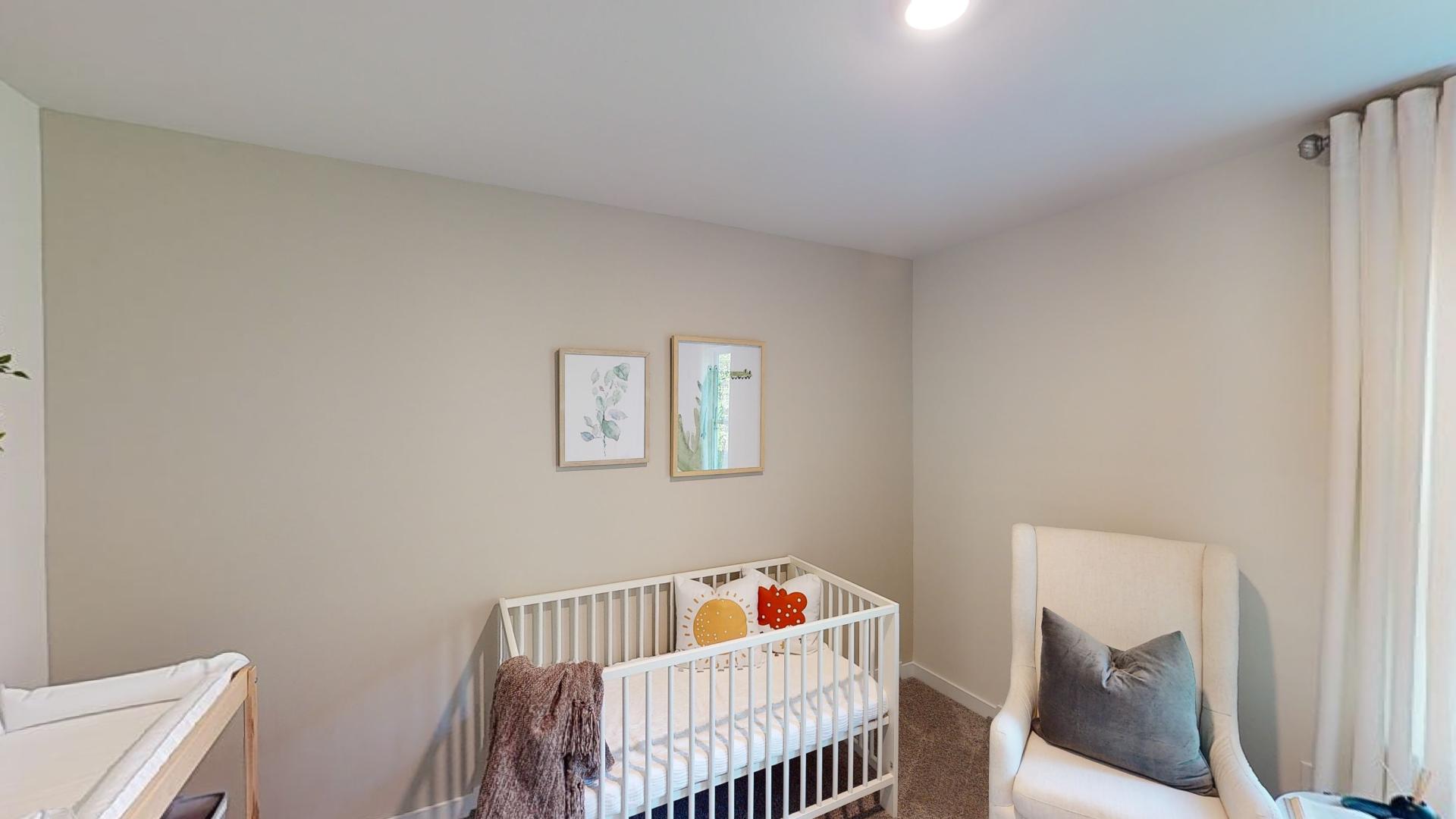 Carpeted bedroom with windows