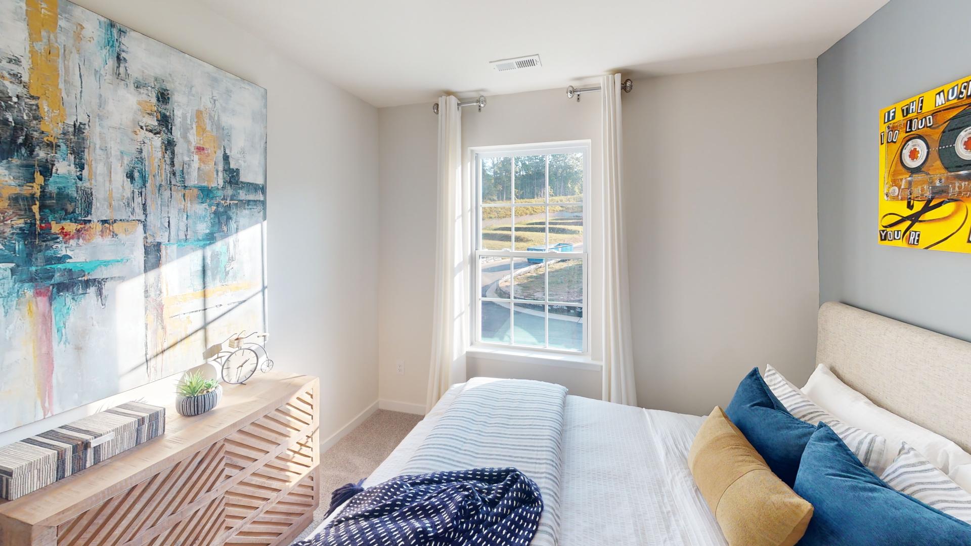 Carpeted bedroom with windows