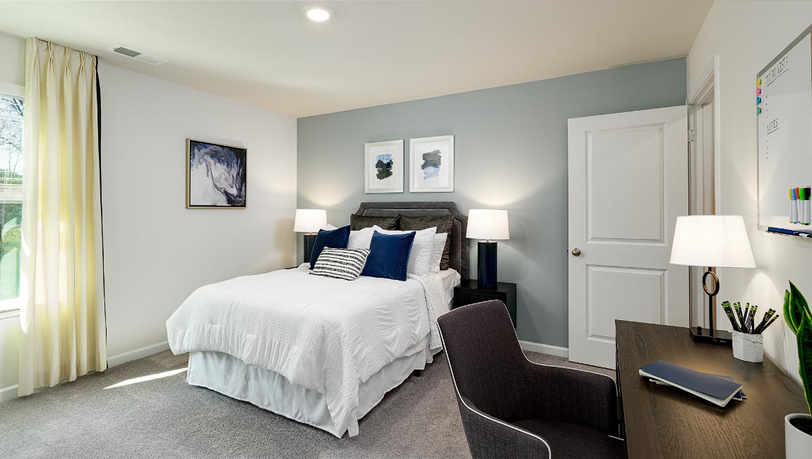 Carpeted bedroom with windows