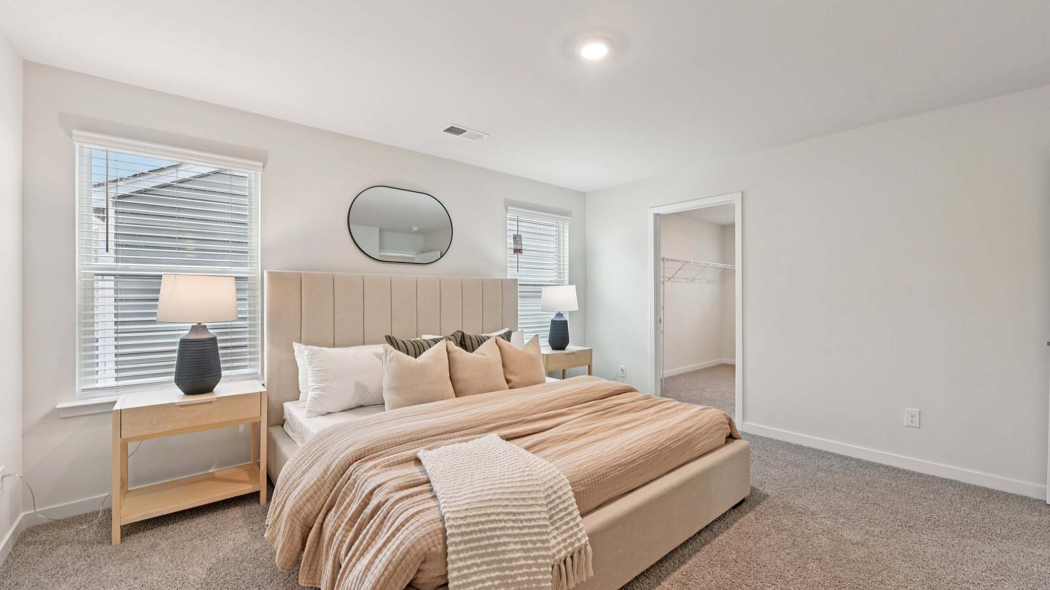 Primary bedroom, carpeted with large windows