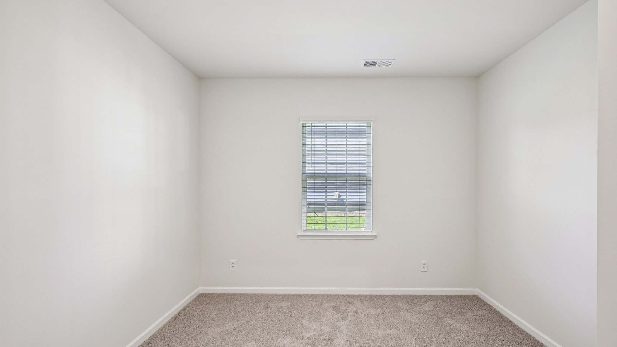 Carpeted bedroom with windows