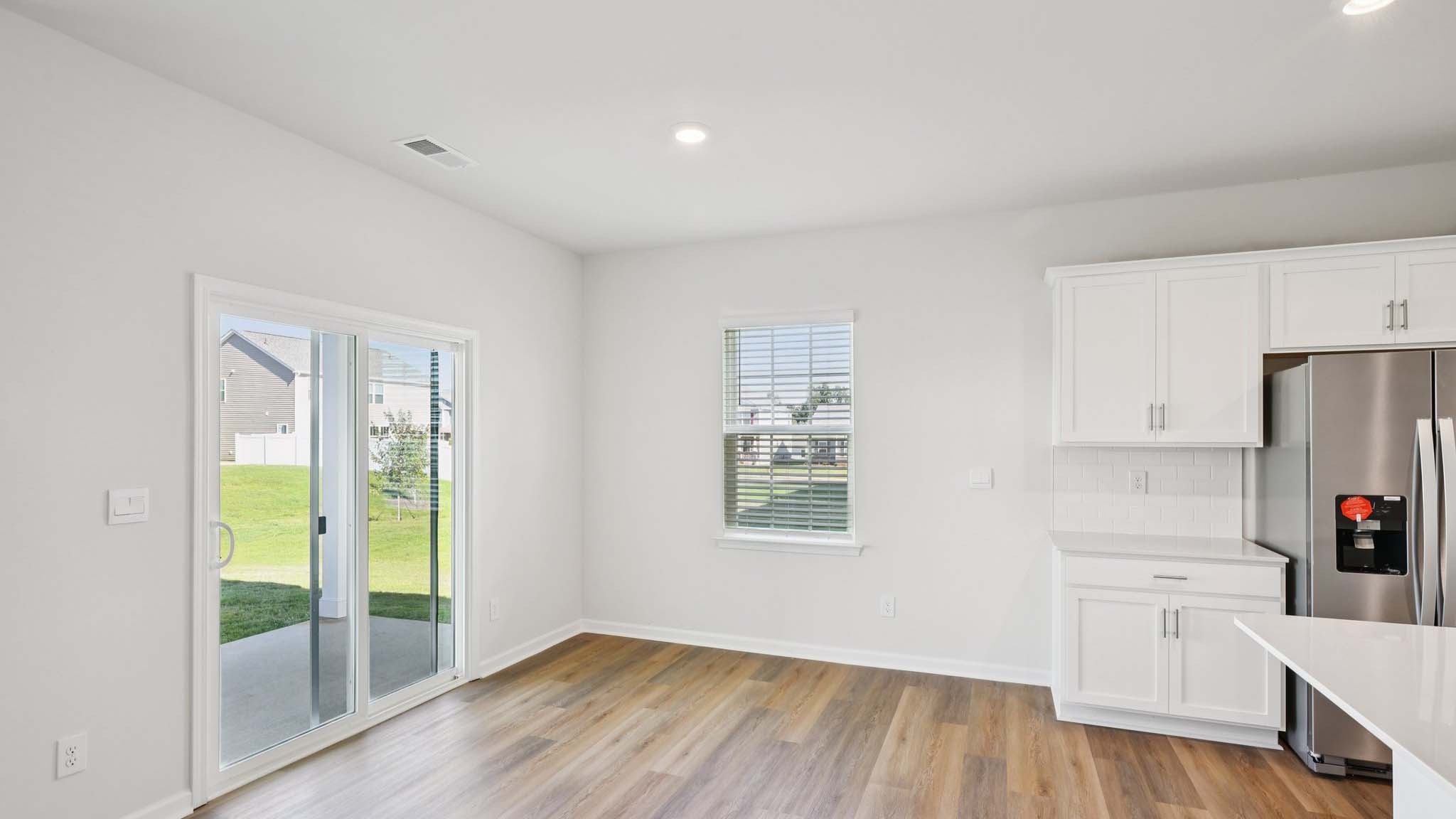 Dining area with wood floors and sliding glass back door