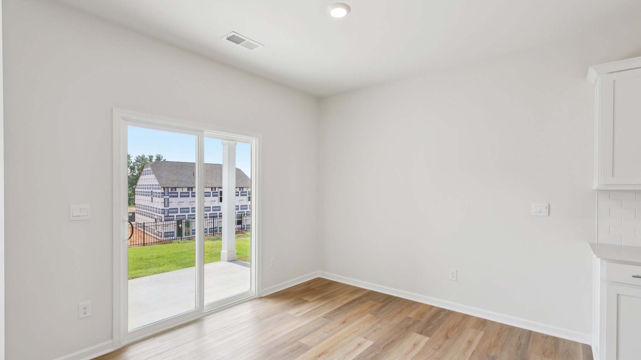 Dining area with wood floors and sliding glass back door