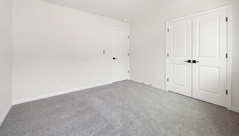 Carpeted bedroom with large window