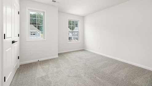Carpeted bedroom with large window