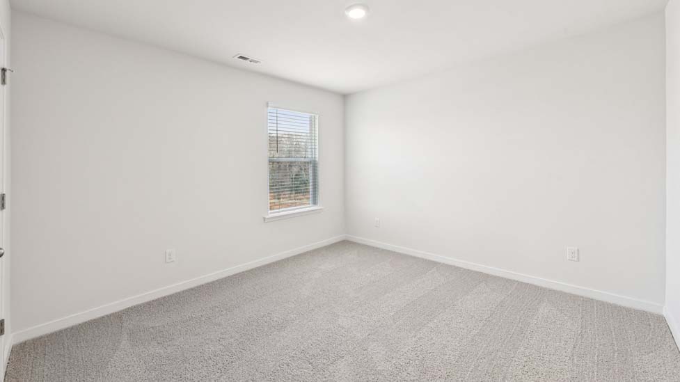 Carpeted bedroom with windows