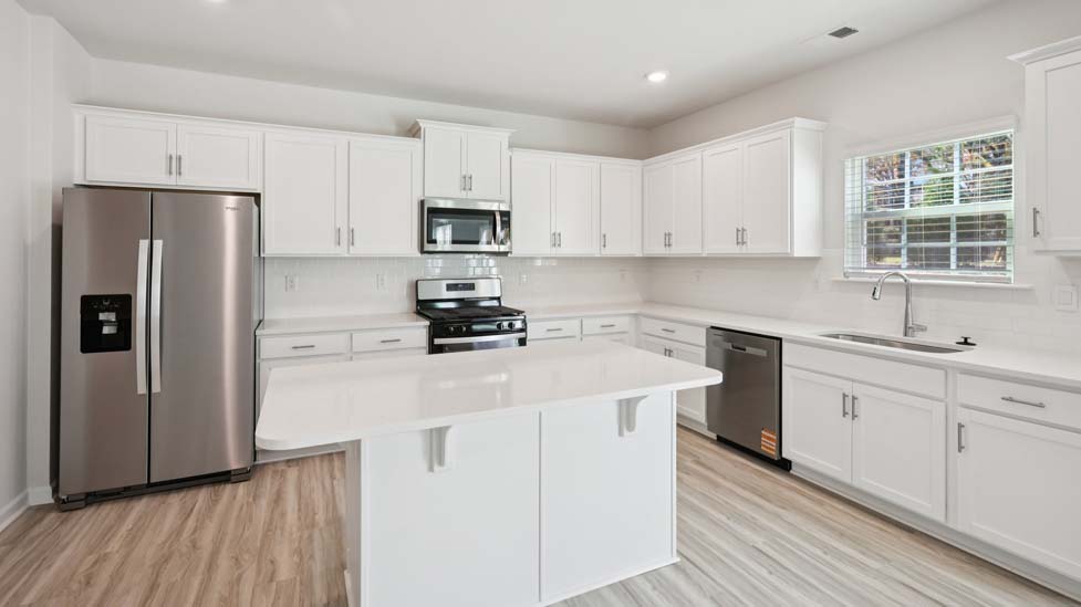 Kitchen and island with white cabinets and counters