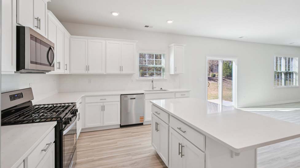 Kitchen and island with white cabinets and counters