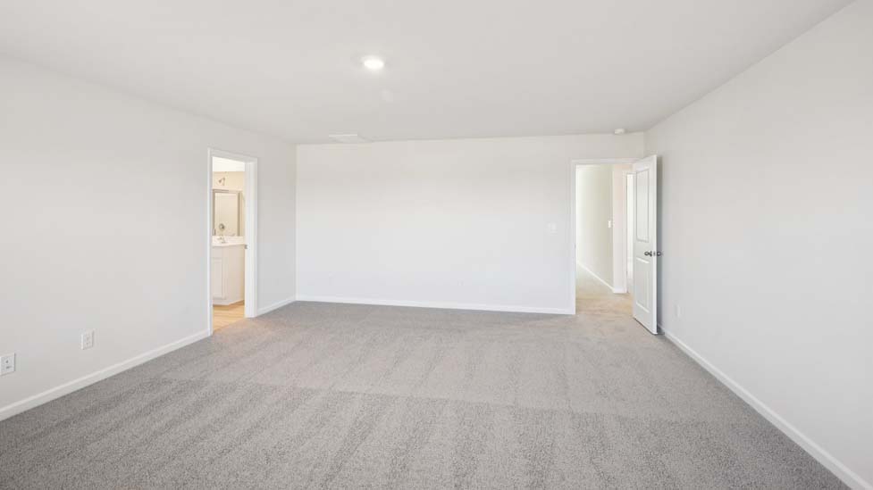 Primary suite, carpeted with two large windows