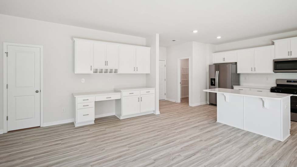 Kitchen and island with white cabinets and counters