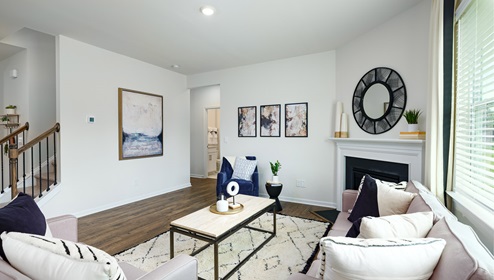 Open living room with large window, and fireplace
