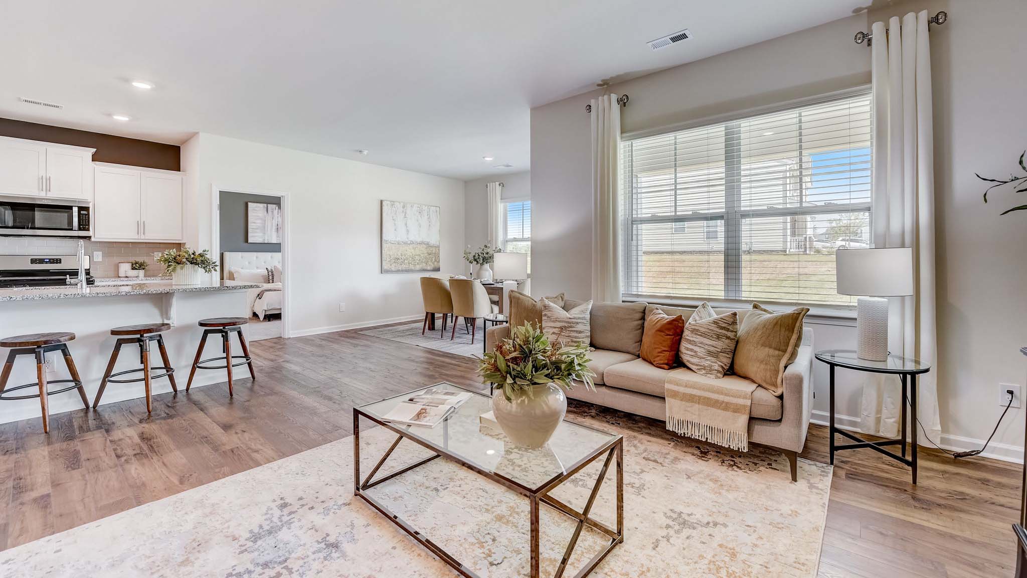 Open concept family room beside kitchen with fireplace