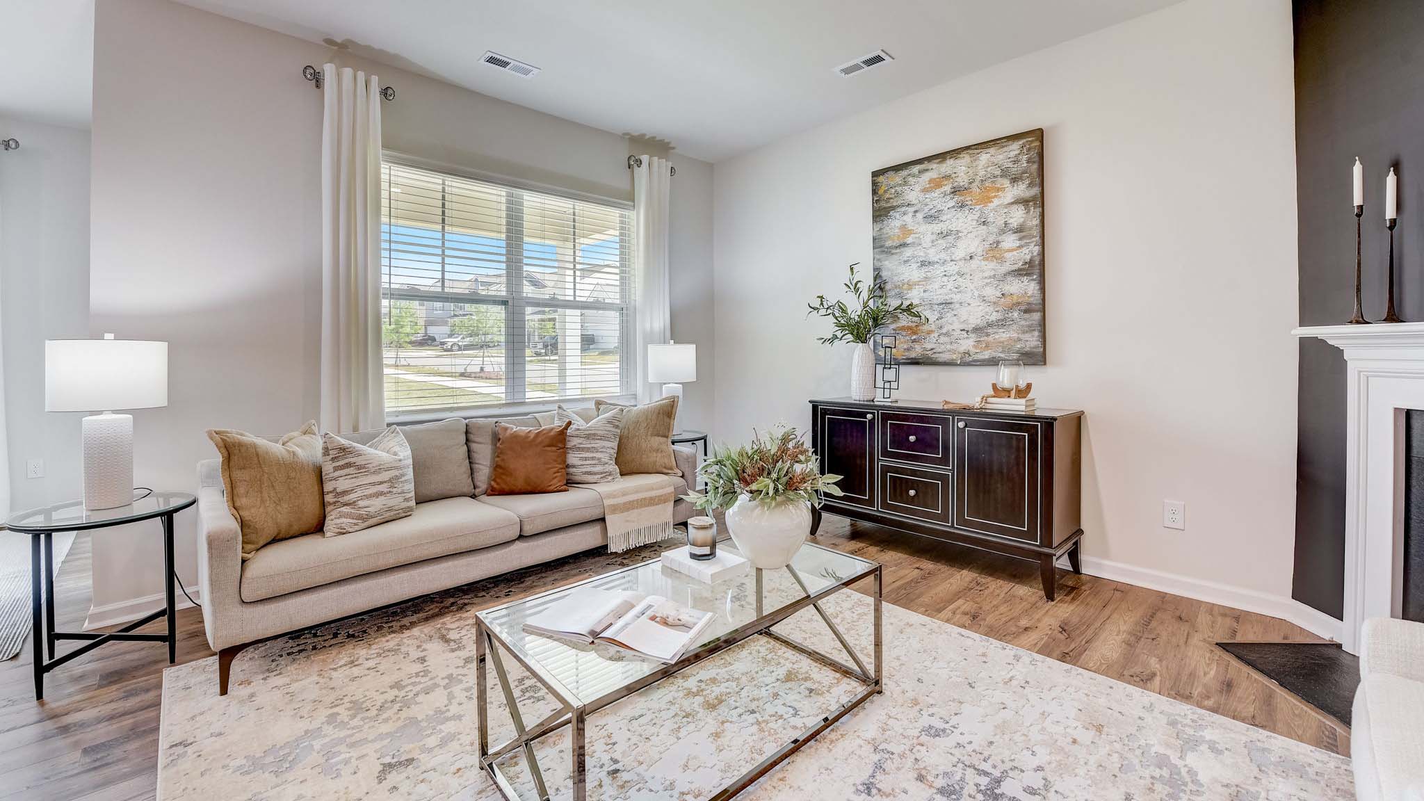 Open concept family room beside kitchen with fireplace