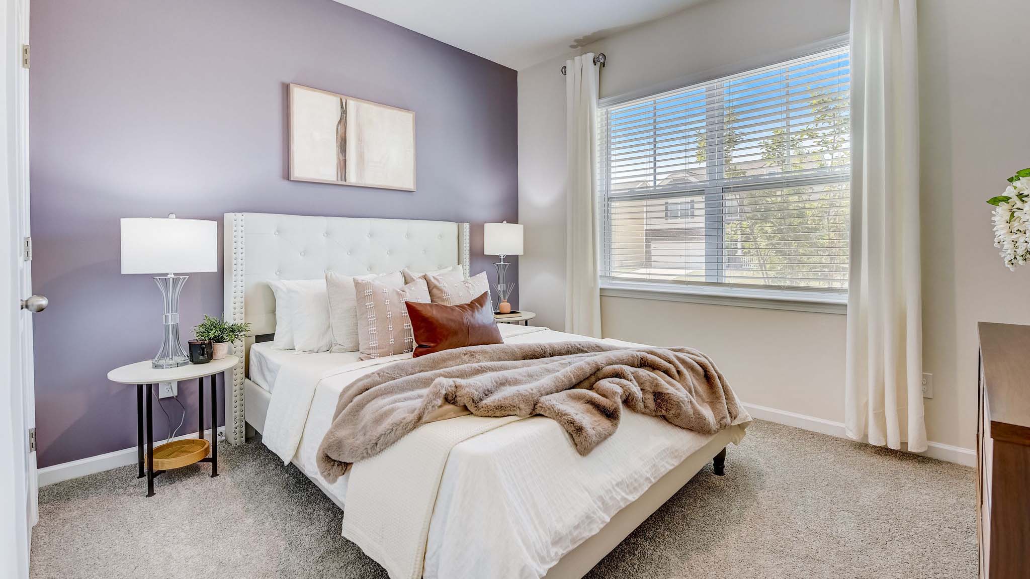 Carpeted bedroom with large window