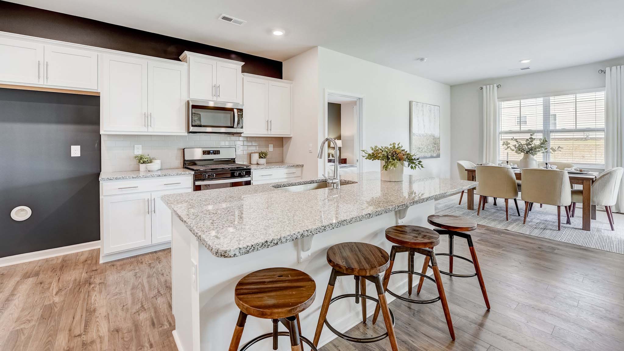 kitchen and island with white cabinets and counters, and stainless steel appliances