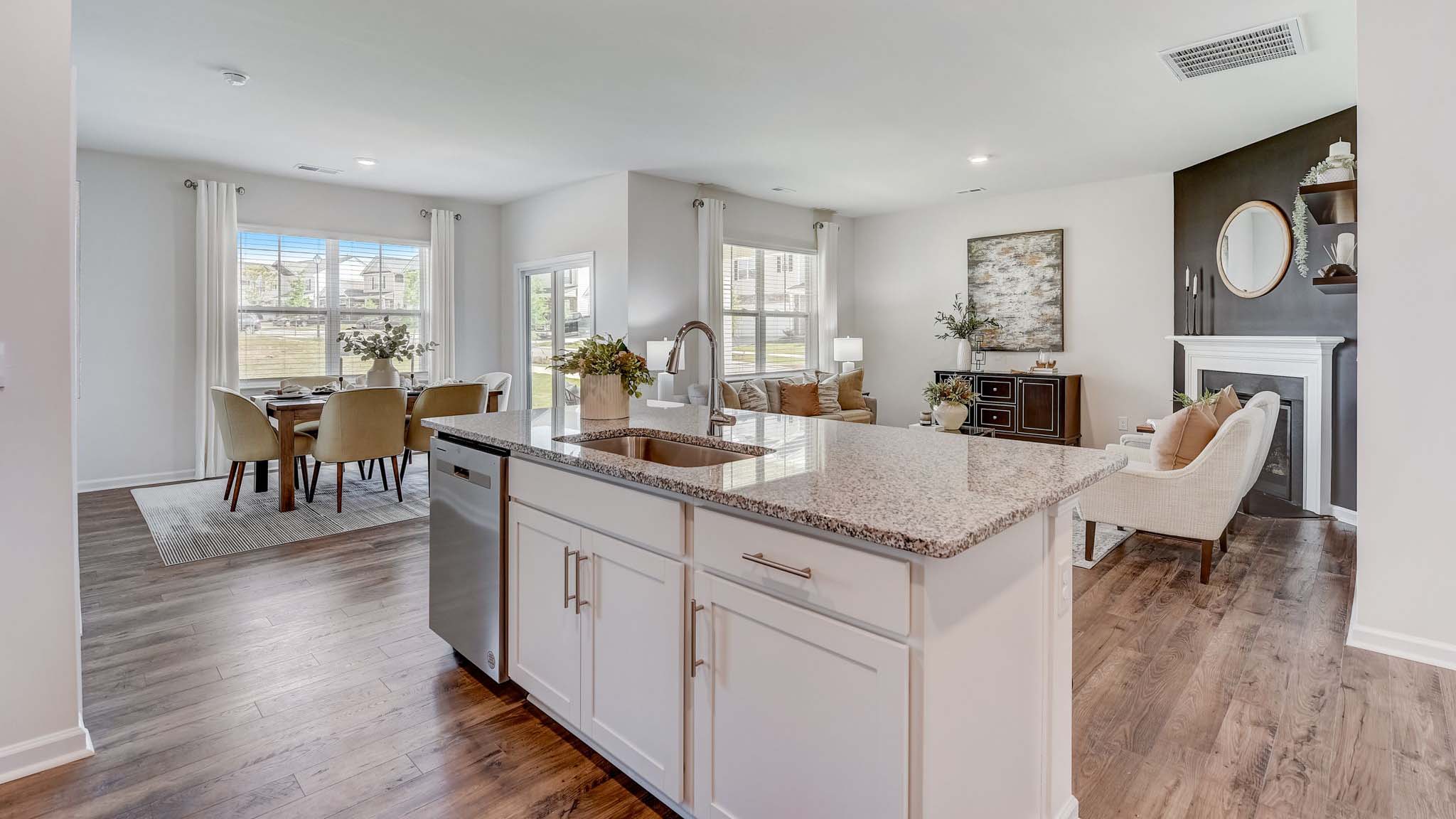 kitchen and island with white cabinets and counters, and stainless steel appliances