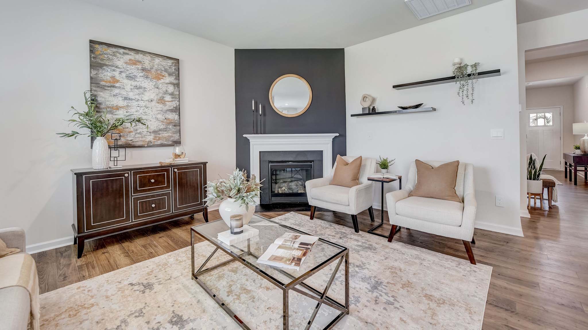 Open concept family room beside kitchen with fireplace