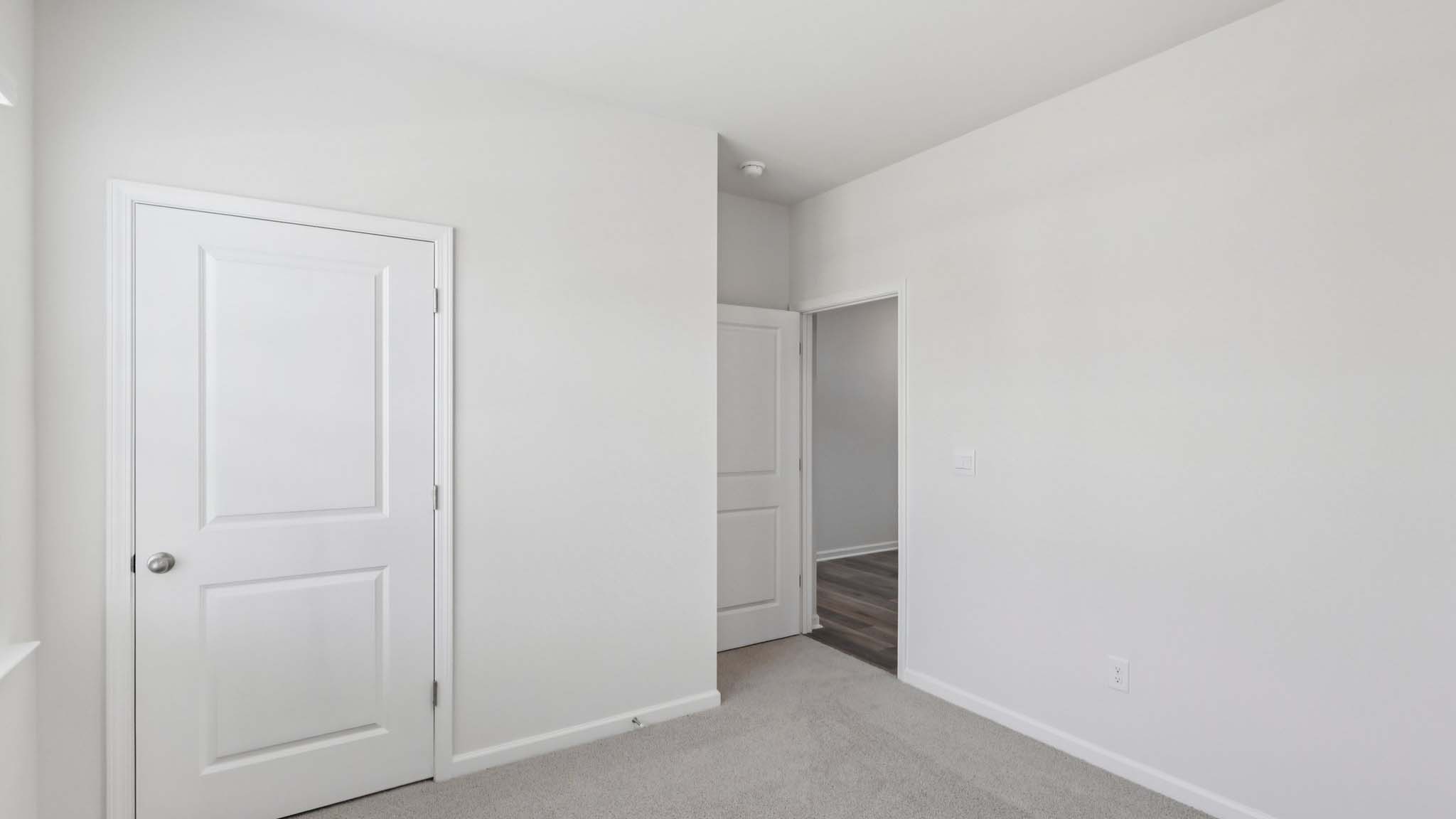 Carpeted bedroom with large window