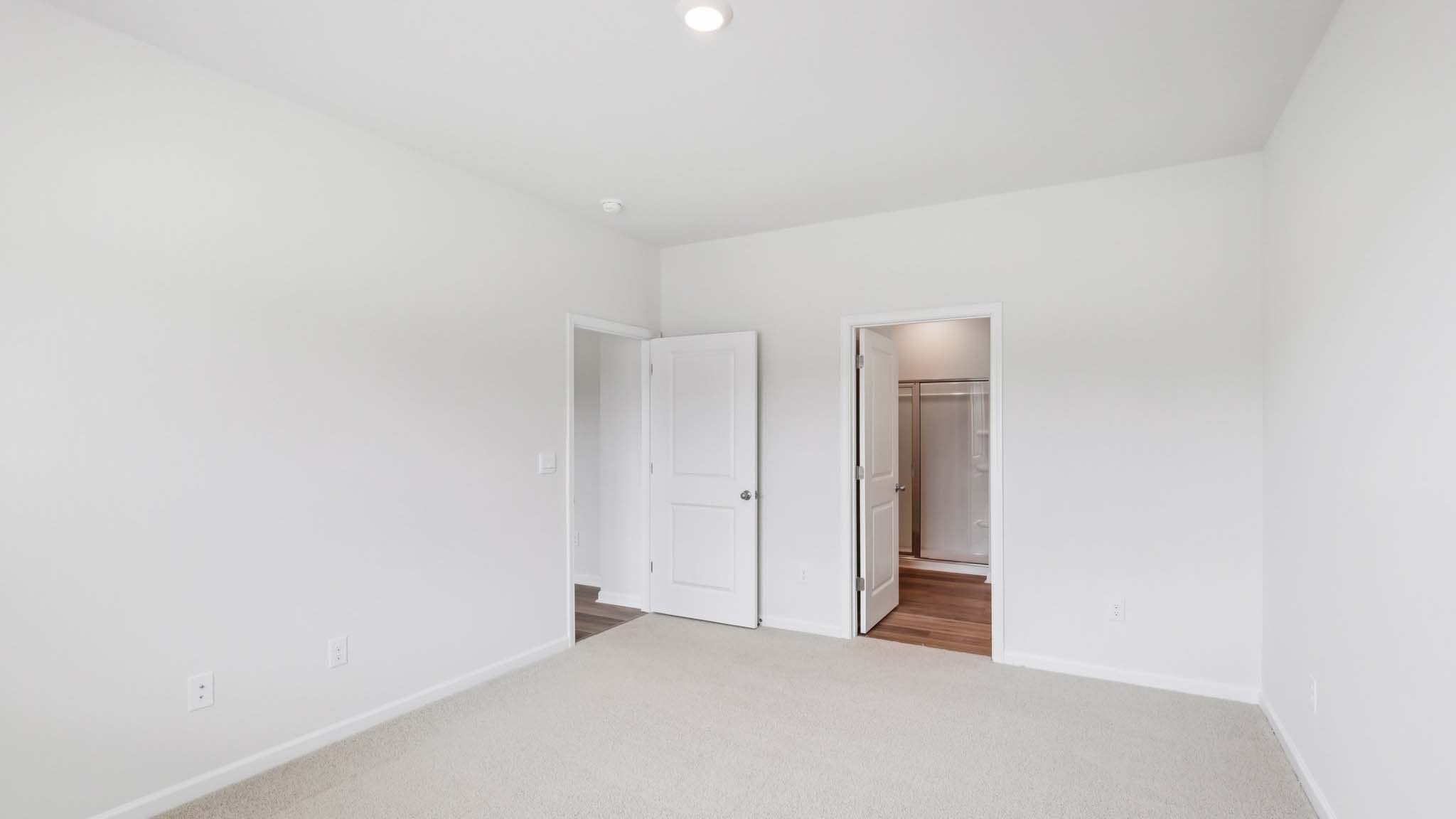 Carpeted bedroom with large window
