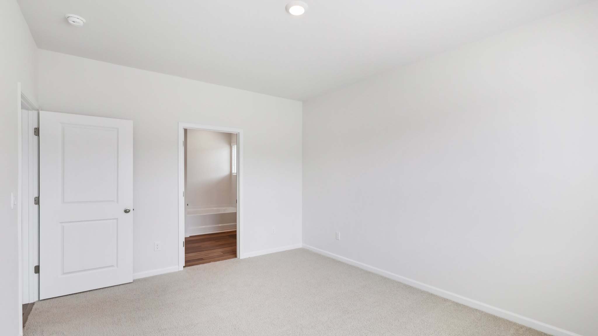 Carpeted bedroom with large window