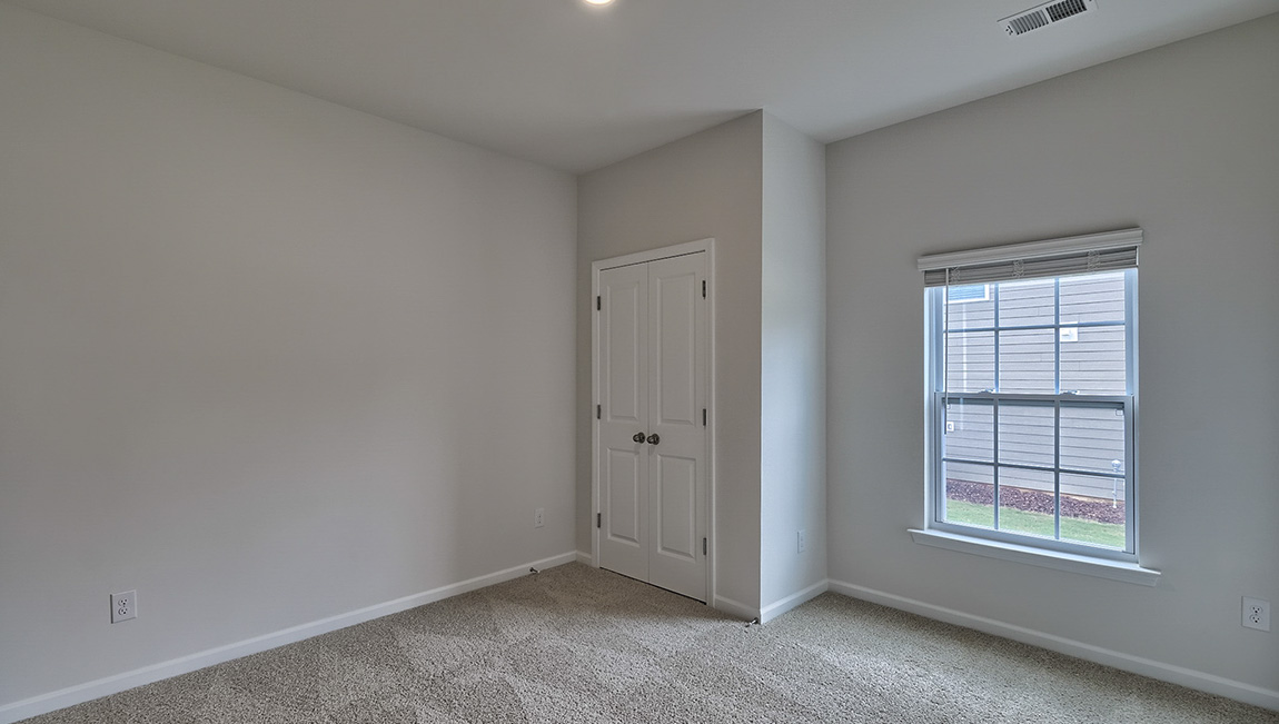 Carpeted bedroom with windows