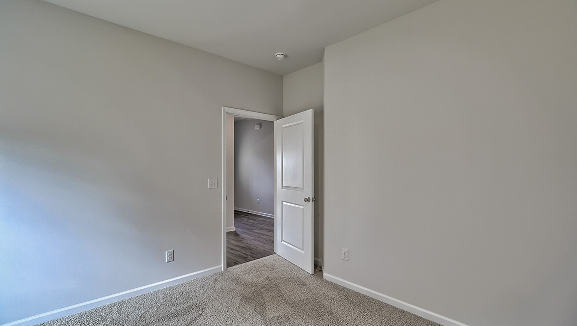 Carpeted bedroom with windows