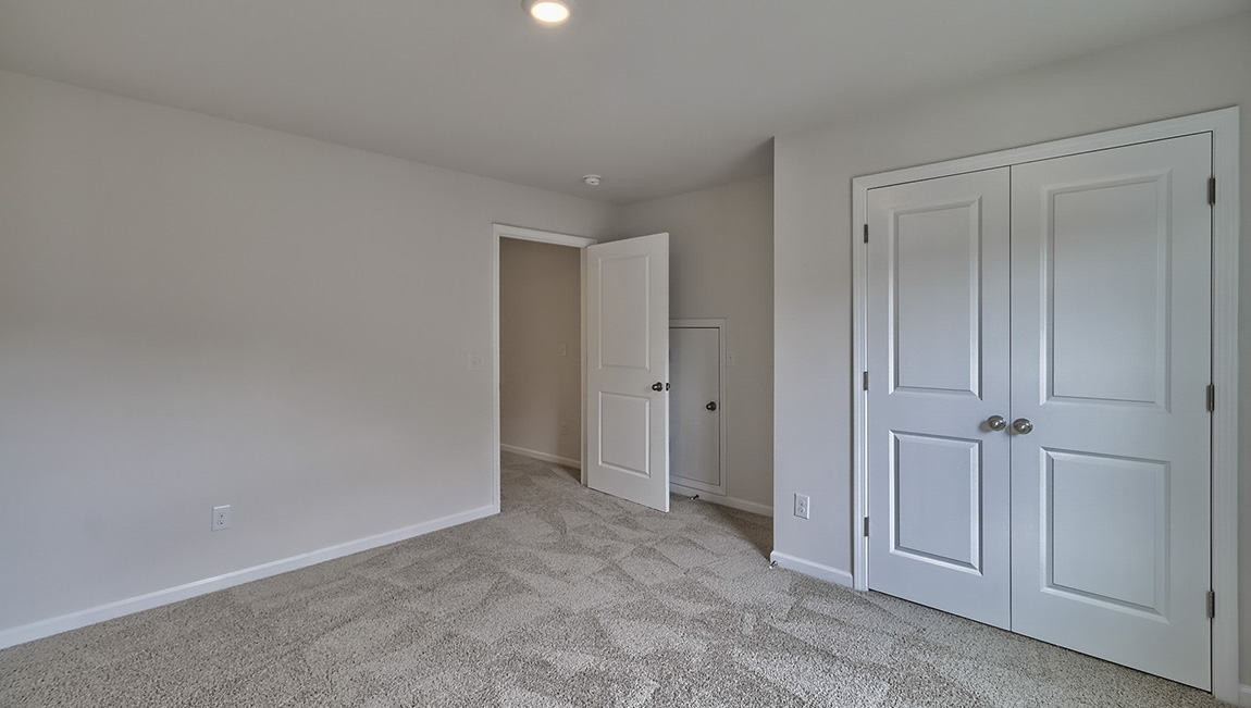 Carpeted bedroom with windows