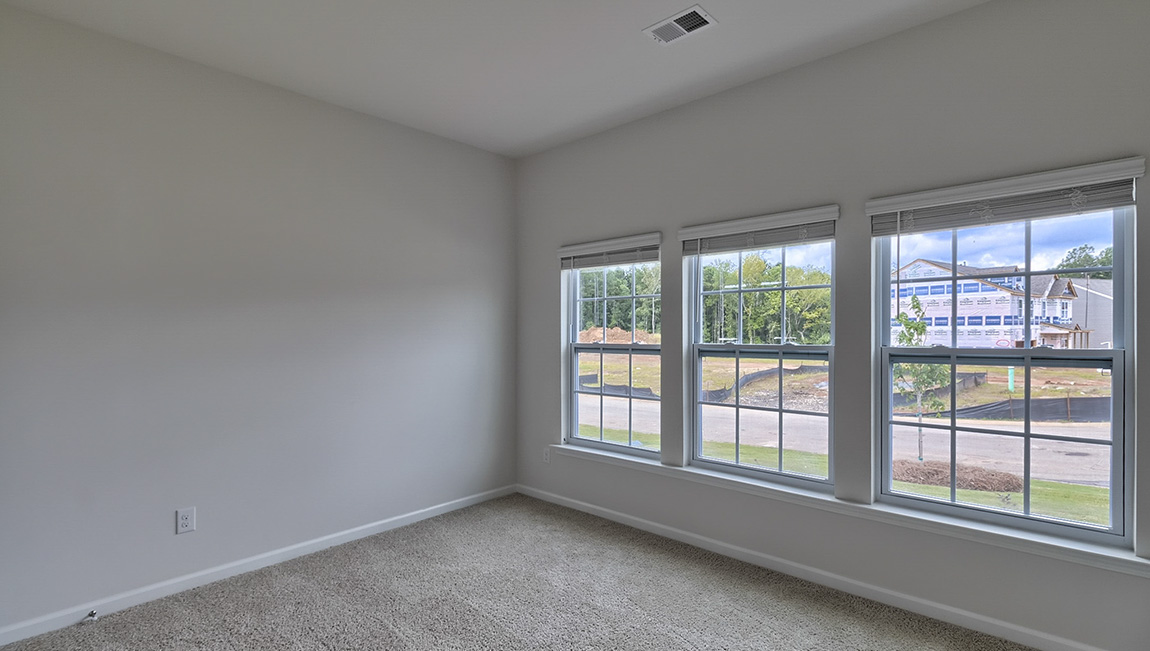Carpeted bedroom with windows