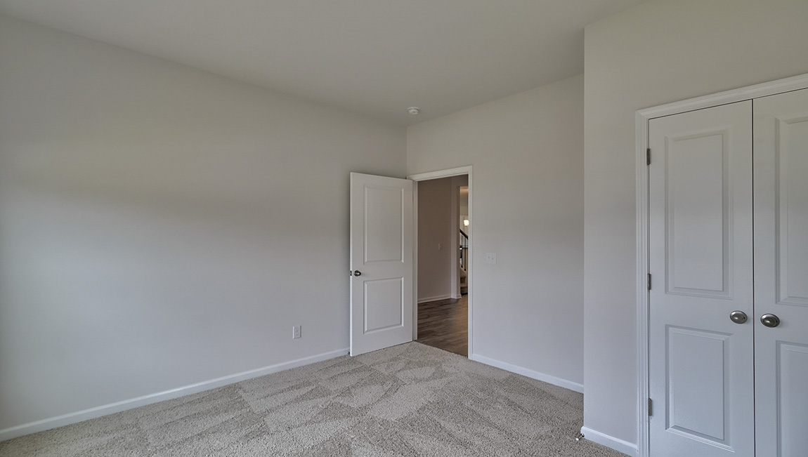 Carpeted bedroom with windows