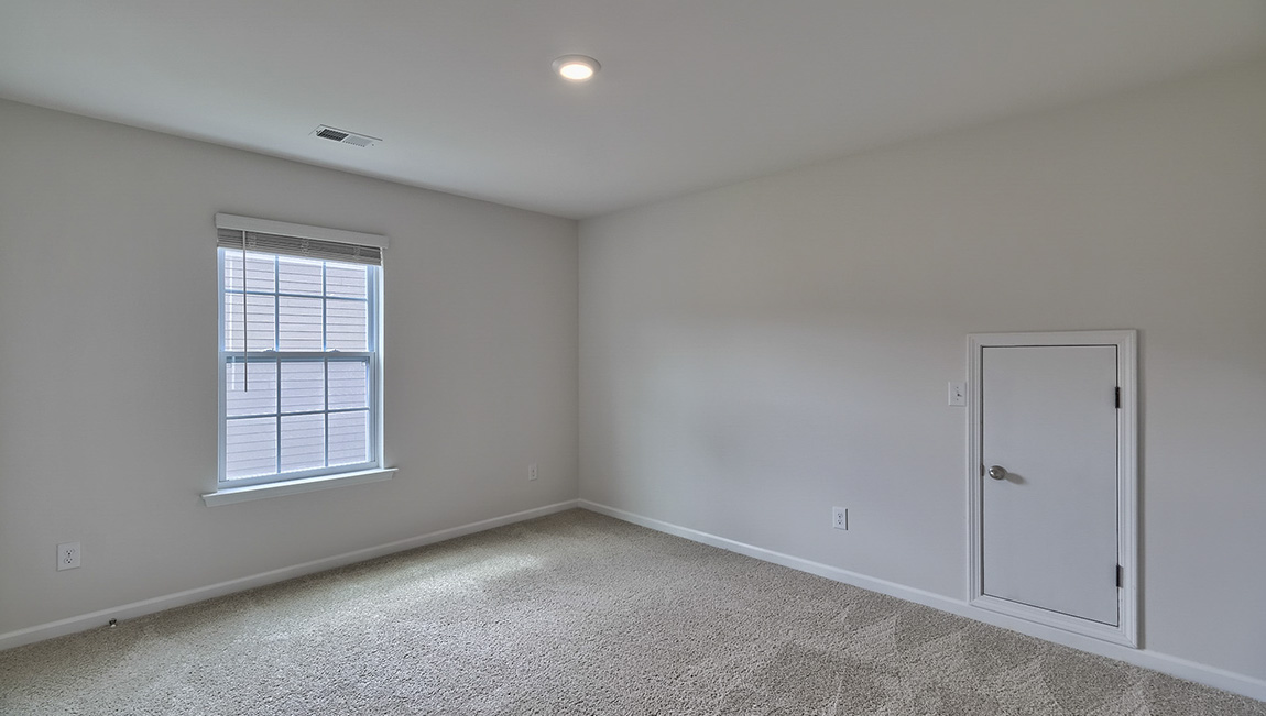 Carpeted bedroom with windows
