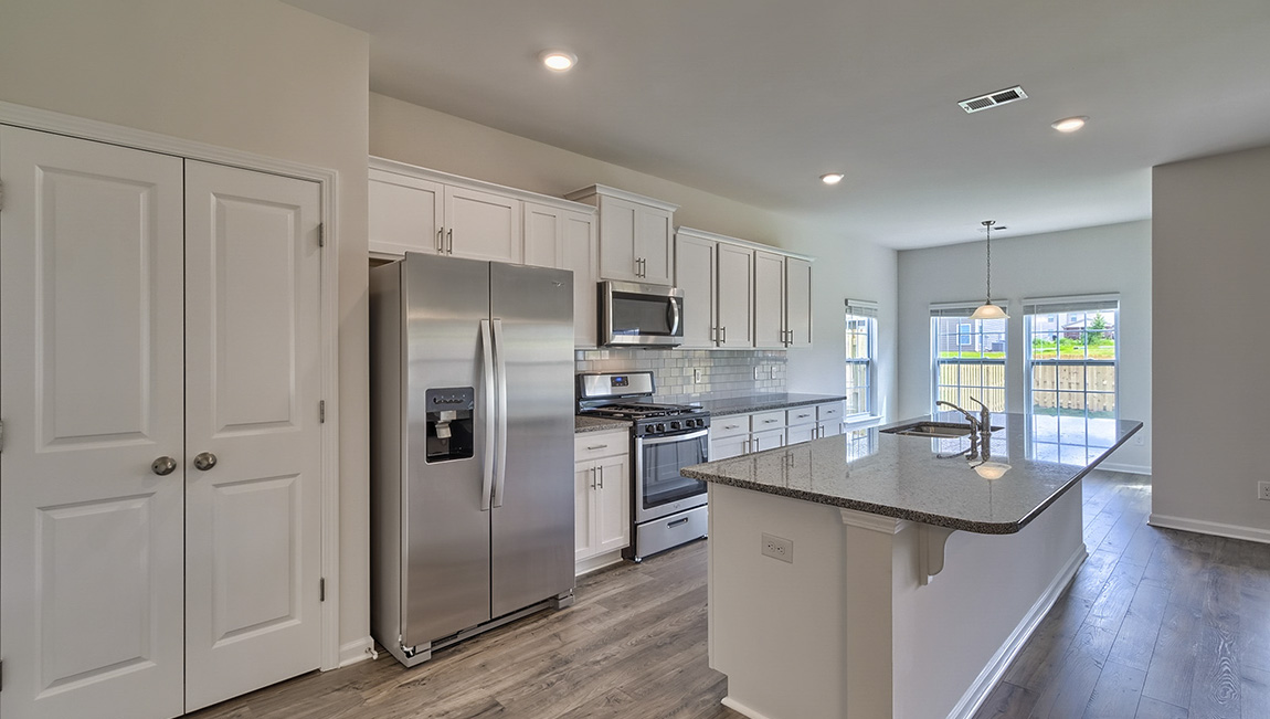 Kitchen and island with stainless steel appliances