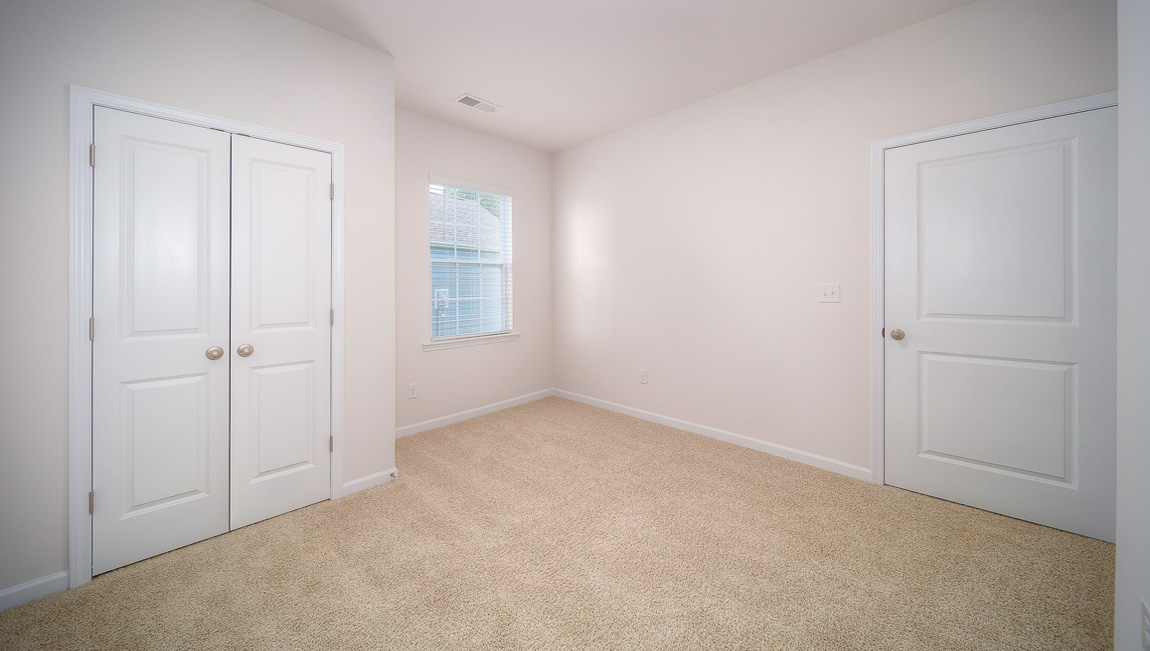 Carpeted bedroom with windows