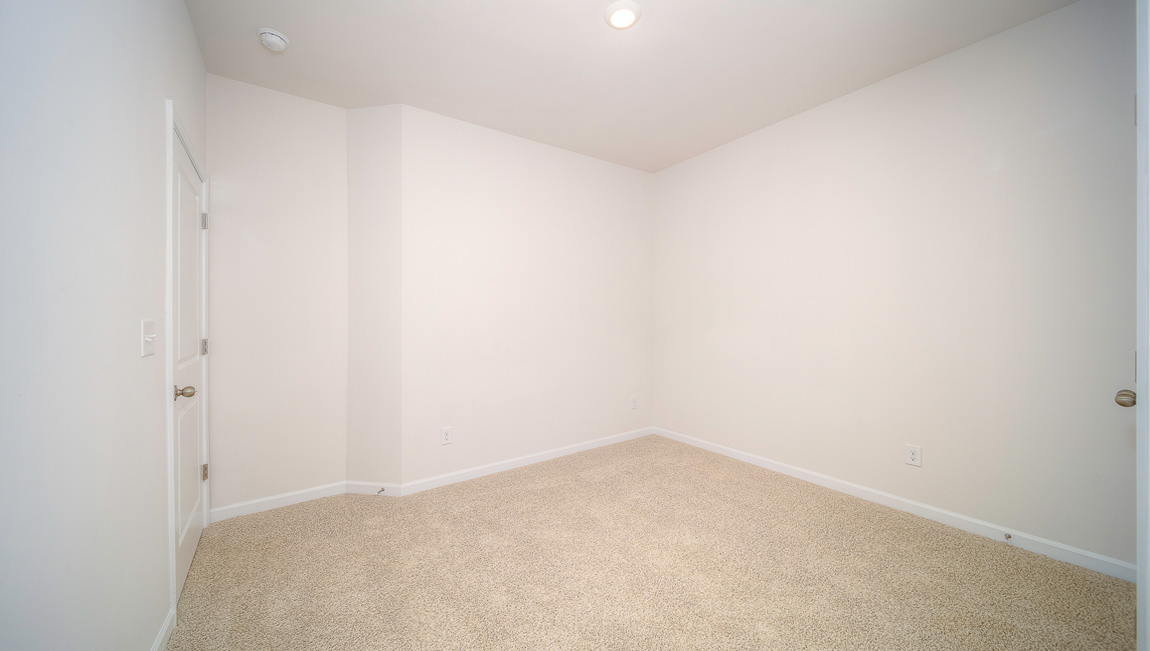 Carpeted bedroom with windows